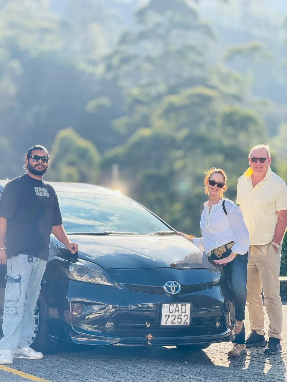 Adhi with Jane and Roger beside his car in the hill country